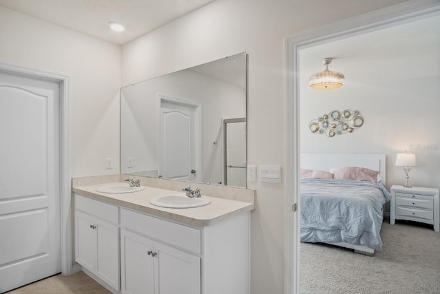 full bathroom featuring double vanity, ensuite bath, and a sink