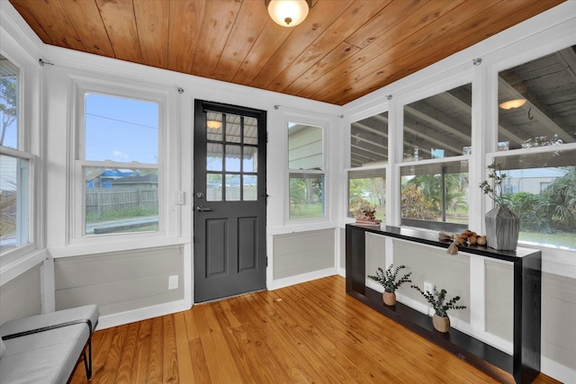 unfurnished sunroom featuring a healthy amount of sunlight and wooden ceiling