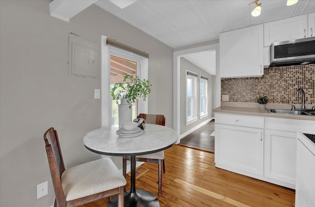 dining space with light wood finished floors and baseboards