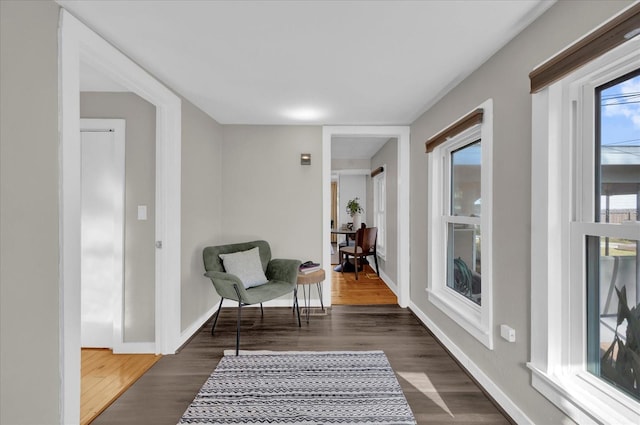 living area with wood finished floors and baseboards