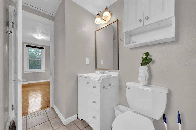 bathroom featuring tile patterned flooring, toilet, vanity, and baseboards