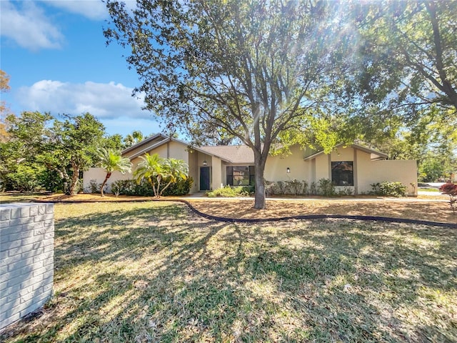 view of front of property with a front yard and stucco siding