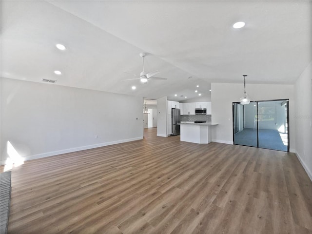 unfurnished living room with a ceiling fan, recessed lighting, light wood-style floors, baseboards, and vaulted ceiling