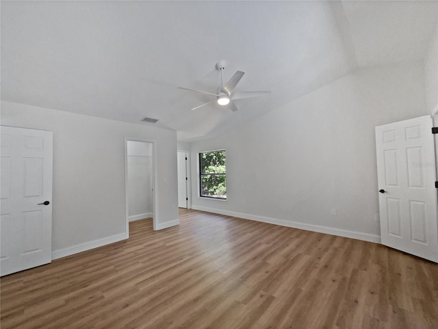 unfurnished bedroom featuring light wood-type flooring, lofted ceiling, baseboards, and ceiling fan