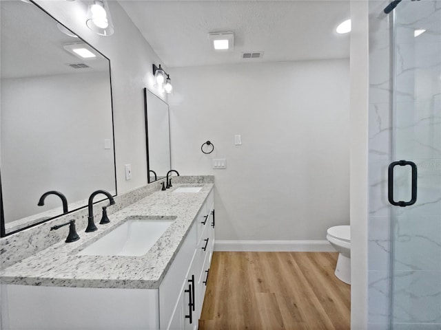 full bath featuring wood finished floors, visible vents, and a sink