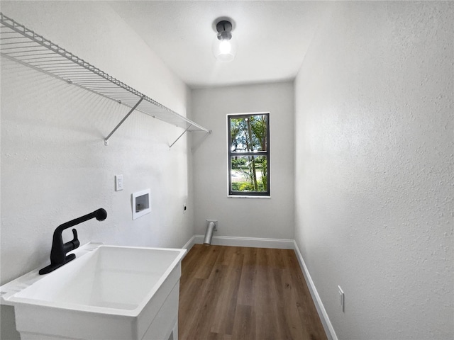 washroom featuring baseboards, laundry area, hookup for a washing machine, hookup for an electric dryer, and a sink