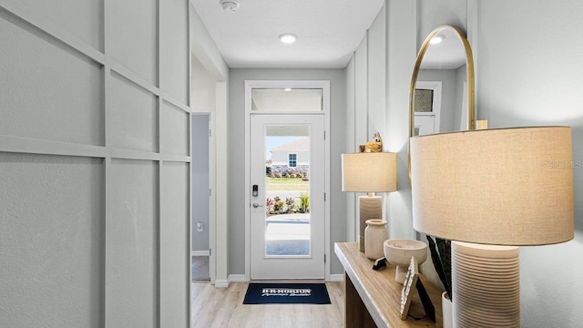 entryway with baseboards and wood finished floors