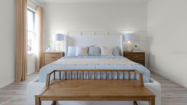 bedroom featuring baseboards and light wood-style flooring