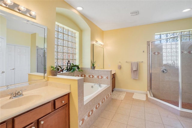 bathroom with tile patterned flooring, a garden tub, vanity, and a stall shower