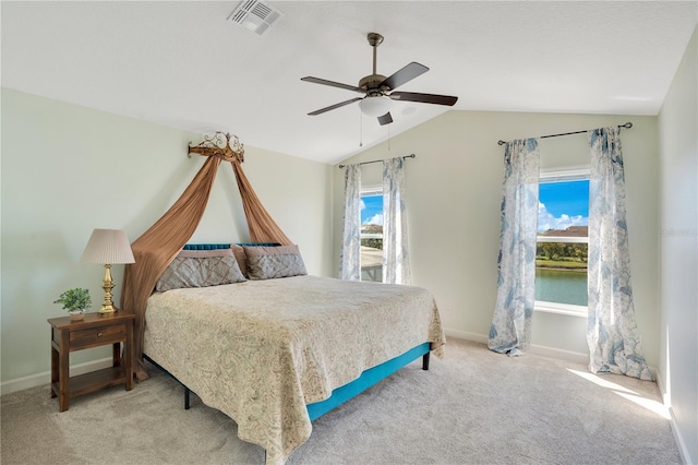 carpeted bedroom featuring vaulted ceiling, a ceiling fan, visible vents, and baseboards