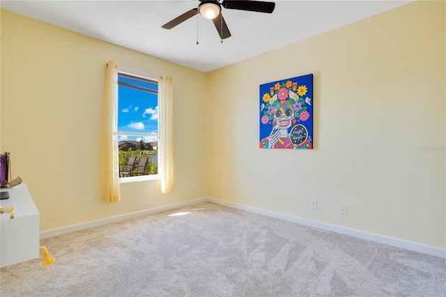 empty room with baseboards, carpet floors, and ceiling fan