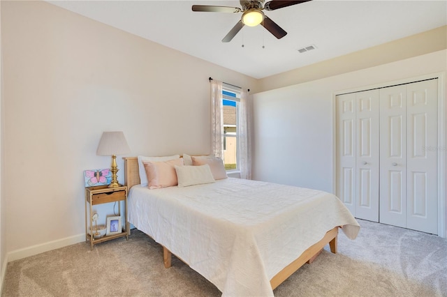 bedroom with visible vents, baseboards, carpet, a closet, and a ceiling fan