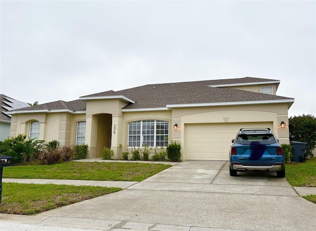 view of front of house with stucco siding, an attached garage, concrete driveway, and a front yard