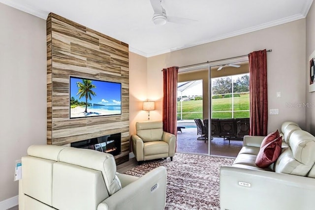 living room featuring a fireplace, a ceiling fan, baseboards, and ornamental molding