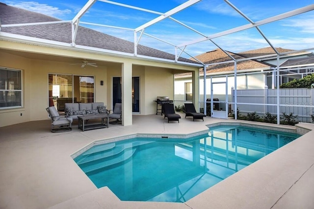 view of pool featuring a patio area, glass enclosure, an outdoor hangout area, and a fenced in pool