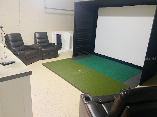 recreation room featuring concrete block wall