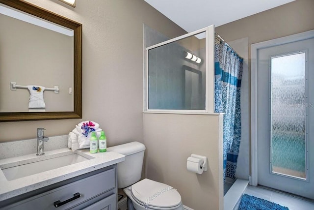 bathroom featuring tile patterned flooring, a stall shower, toilet, and vanity