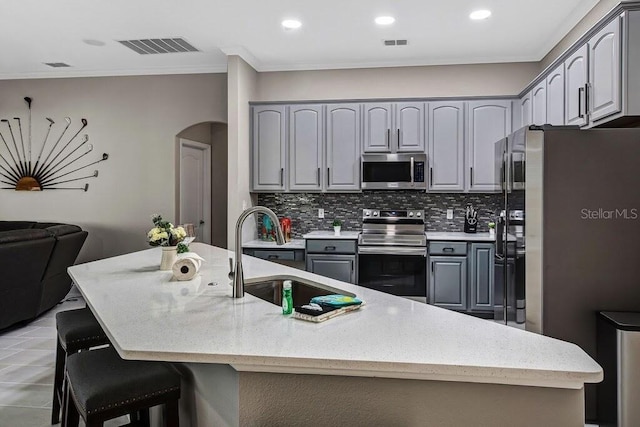 kitchen with a sink, visible vents, gray cabinets, and stainless steel appliances