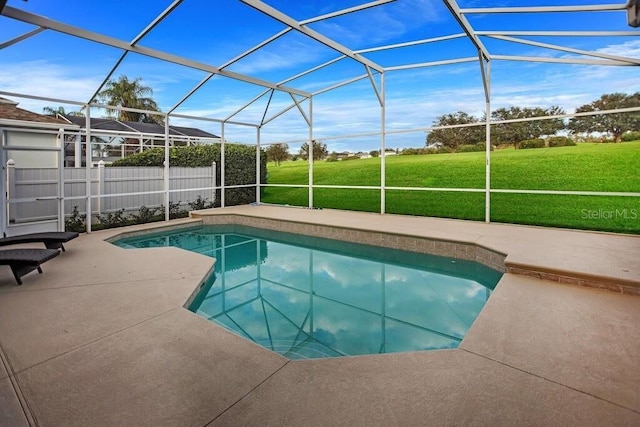 view of pool with glass enclosure, a lawn, a fenced in pool, and a patio area