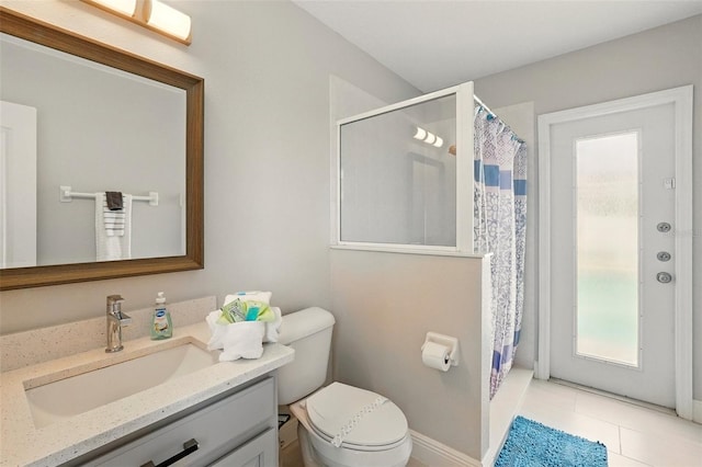full bathroom featuring vanity, toilet, tile patterned floors, and curtained shower