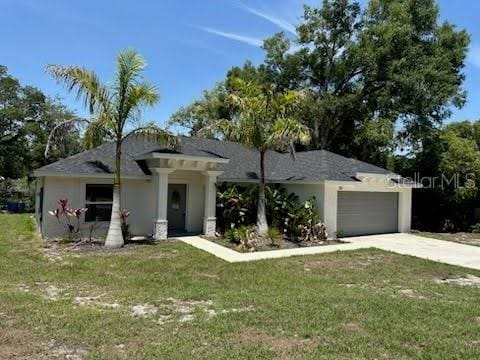 120 S Chandler Ave, Deland, FL 32724 - view of front of home featuring a front yard, driveway, and a garage