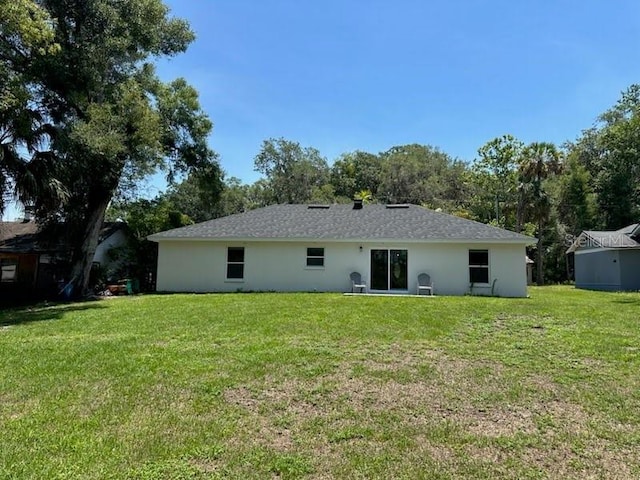 120 S Chandler Ave, Deland, FL 32724 - back of house featuring a lawn and stucco siding