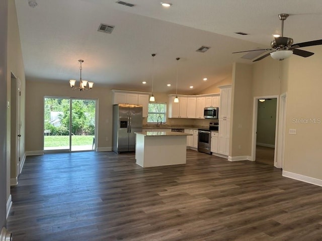 120 S Chandler Ave, Deland, FL 32724 - kitchen with appliances with stainless steel finishes, open floor plan, a kitchen island, a chandelier, and plenty of natural light