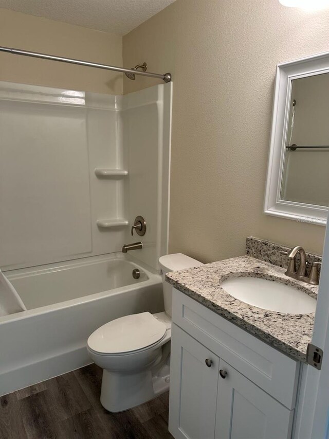 120 S Chandler Ave, Deland, FL 32724 - bathroom with toilet, wood finished floors, vanity, and washtub / shower combination