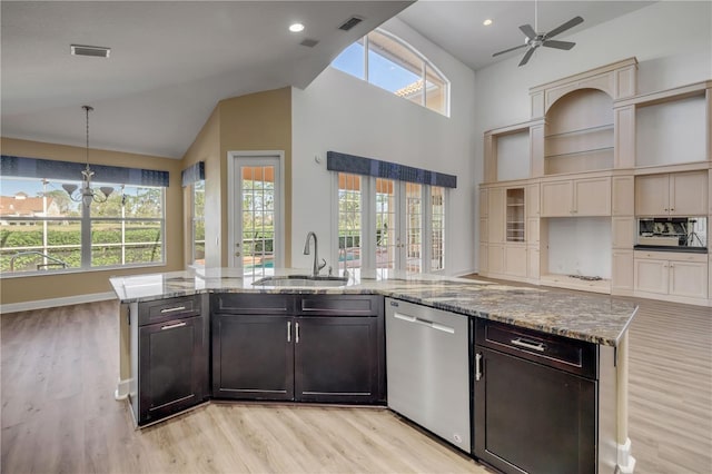 kitchen with visible vents, a ceiling fan, a sink, light stone counters, and stainless steel dishwasher