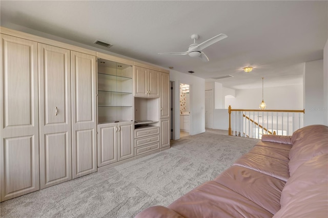 living room with visible vents, light colored carpet, and ceiling fan