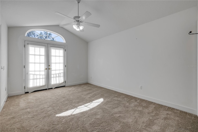 carpeted empty room featuring a ceiling fan, lofted ceiling, french doors, and baseboards