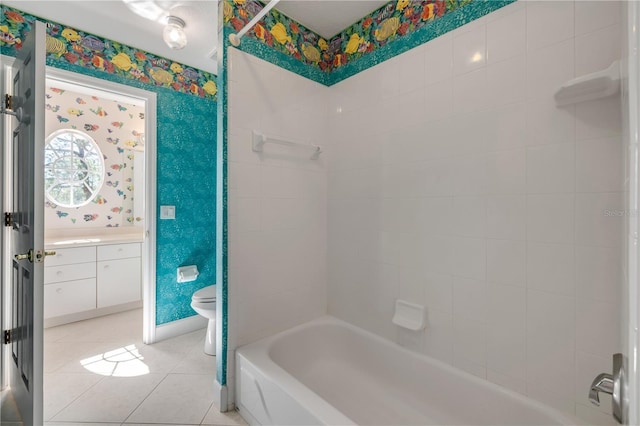 full bathroom featuring tile patterned flooring, wallpapered walls, shower / washtub combination, toilet, and vanity