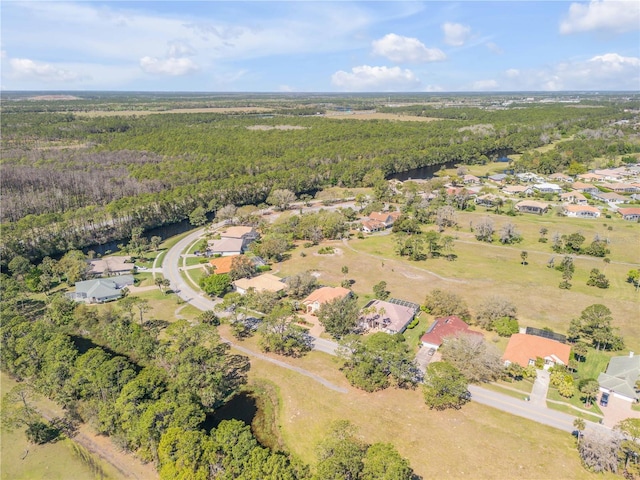 drone / aerial view with a wooded view