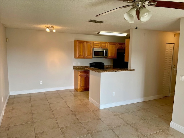 kitchen with stainless steel microwave, visible vents, ceiling fan, electric range oven, and refrigerator