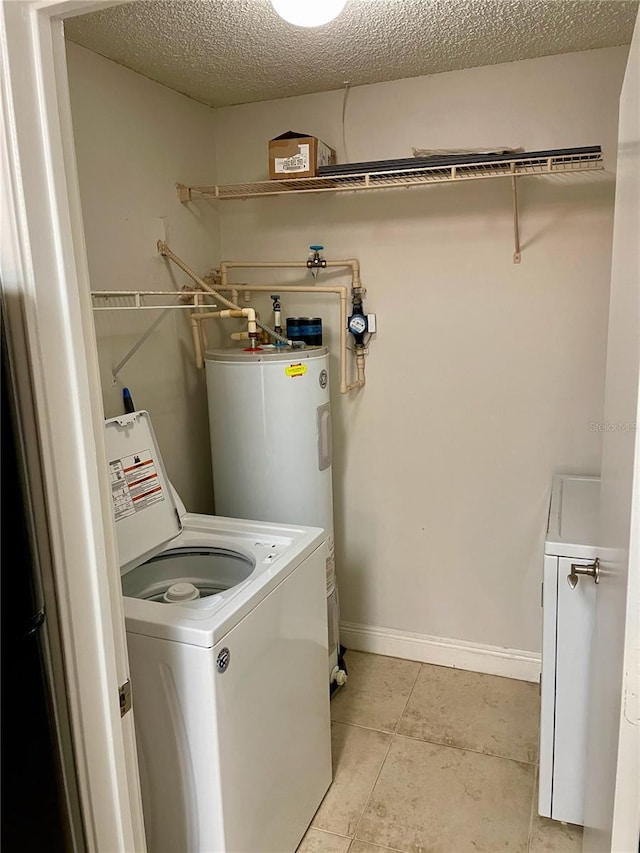 laundry room featuring washer / clothes dryer, a textured ceiling, water heater, baseboards, and laundry area