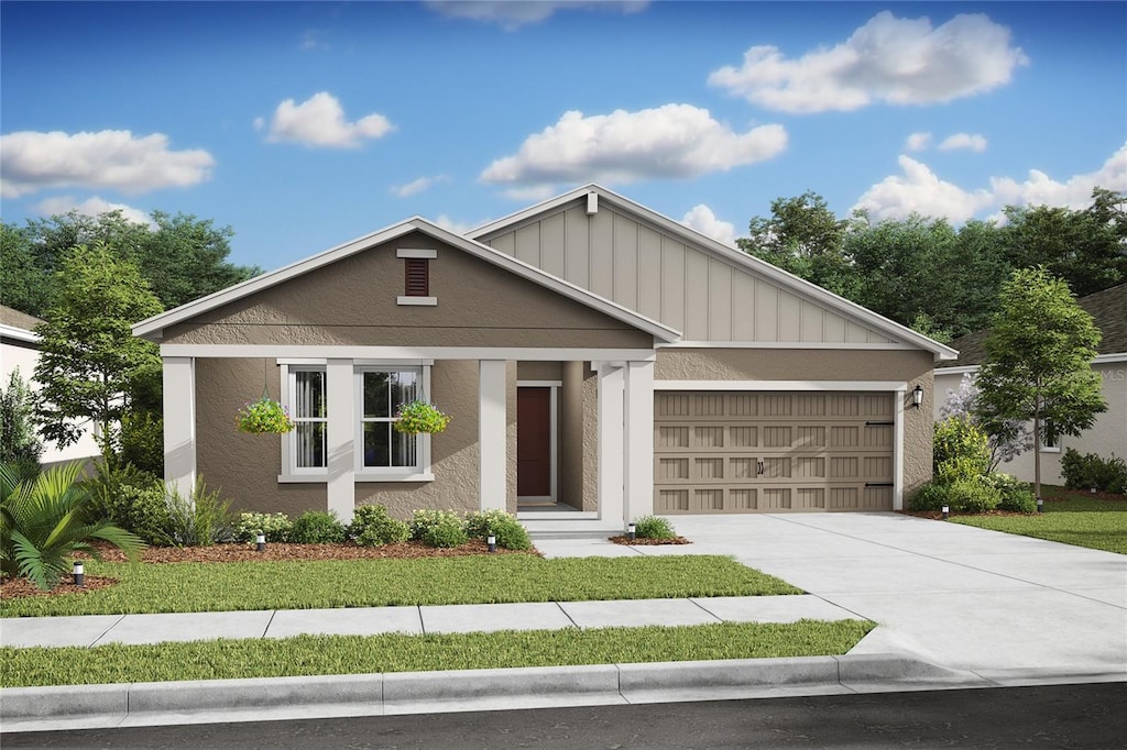 view of front of property with an attached garage, driveway, and stucco siding