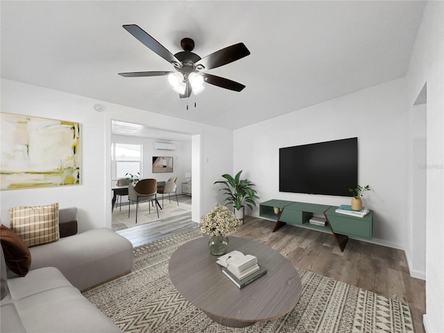 living room featuring ceiling fan, a wall mounted air conditioner, and wood finished floors