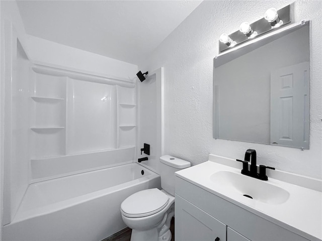 full bathroom featuring vanity, toilet, a textured wall, and bathtub / shower combination