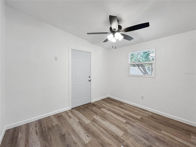 unfurnished room with ceiling fan, baseboards, and wood finished floors