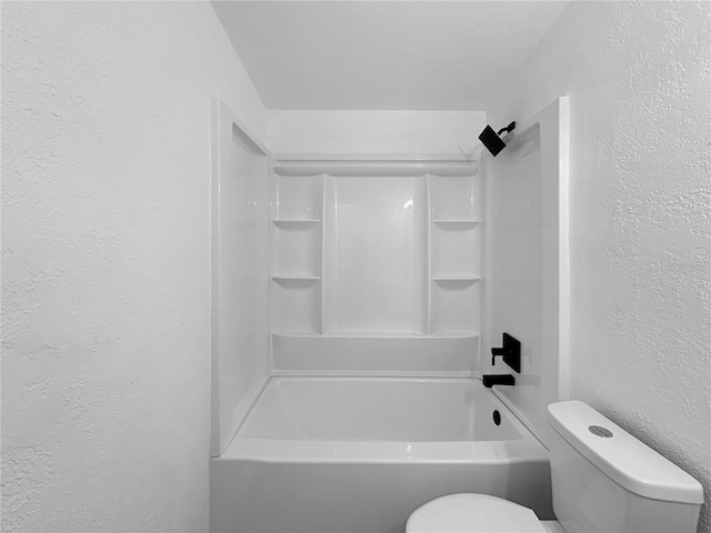 full bath featuring toilet, shower / bathtub combination, and a textured wall