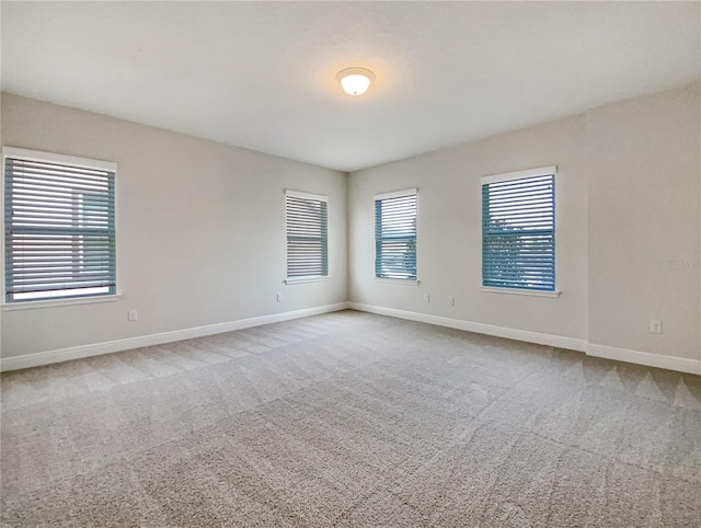 unfurnished room featuring baseboards and carpet floors