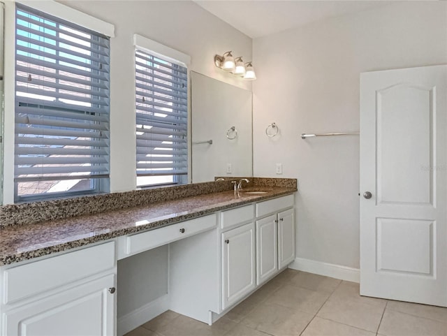 bathroom with tile patterned flooring, vanity, and baseboards