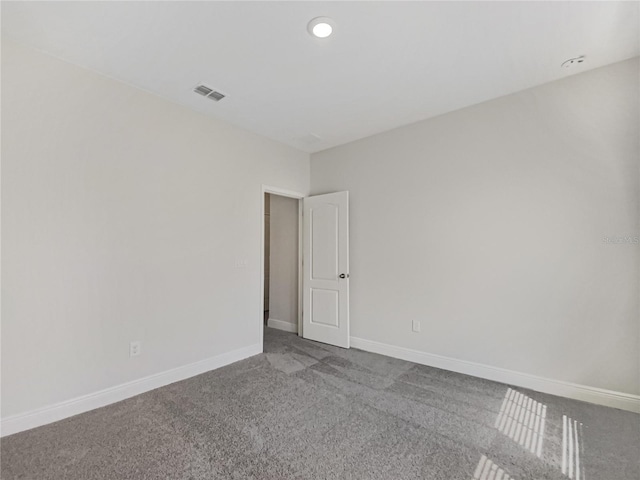 carpeted empty room featuring recessed lighting, baseboards, and visible vents