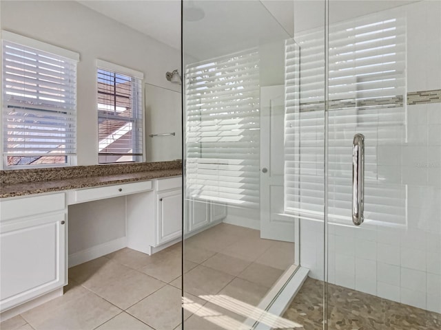 full bath with tile patterned flooring and a tile shower