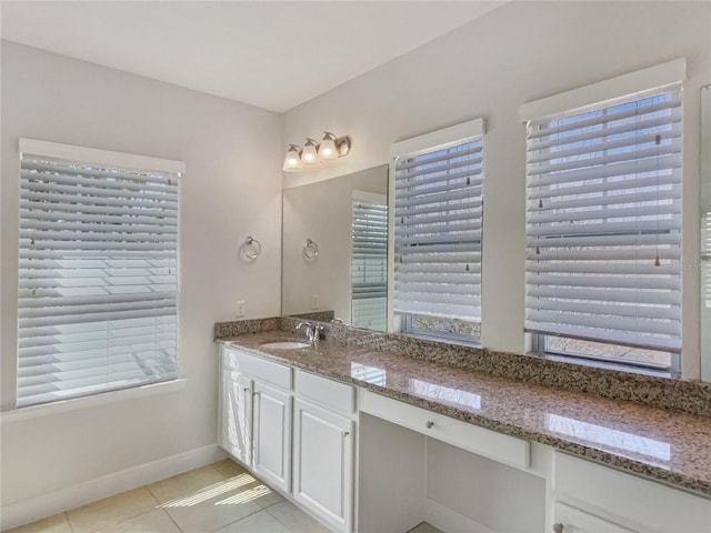 bathroom with vanity, tile patterned floors, and baseboards