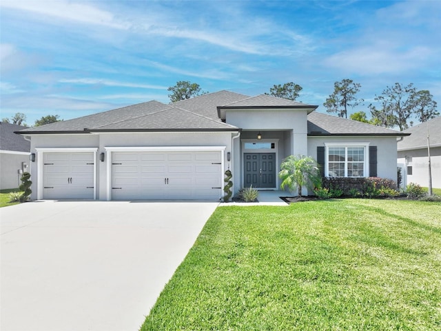 prairie-style home with a front yard, roof with shingles, driveway, an attached garage, and stucco siding