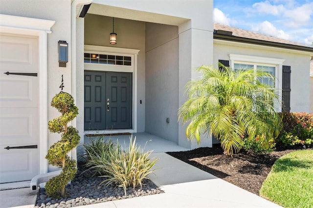 entrance to property featuring stucco siding