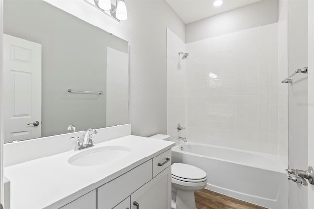 bathroom with vanity,  shower combination, toilet, and wood finished floors