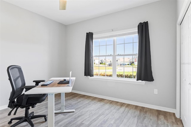 office featuring baseboards and wood finished floors