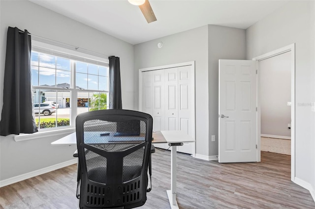 interior space with wood finished floors, baseboards, and ceiling fan